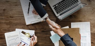 Business people shaking hands together