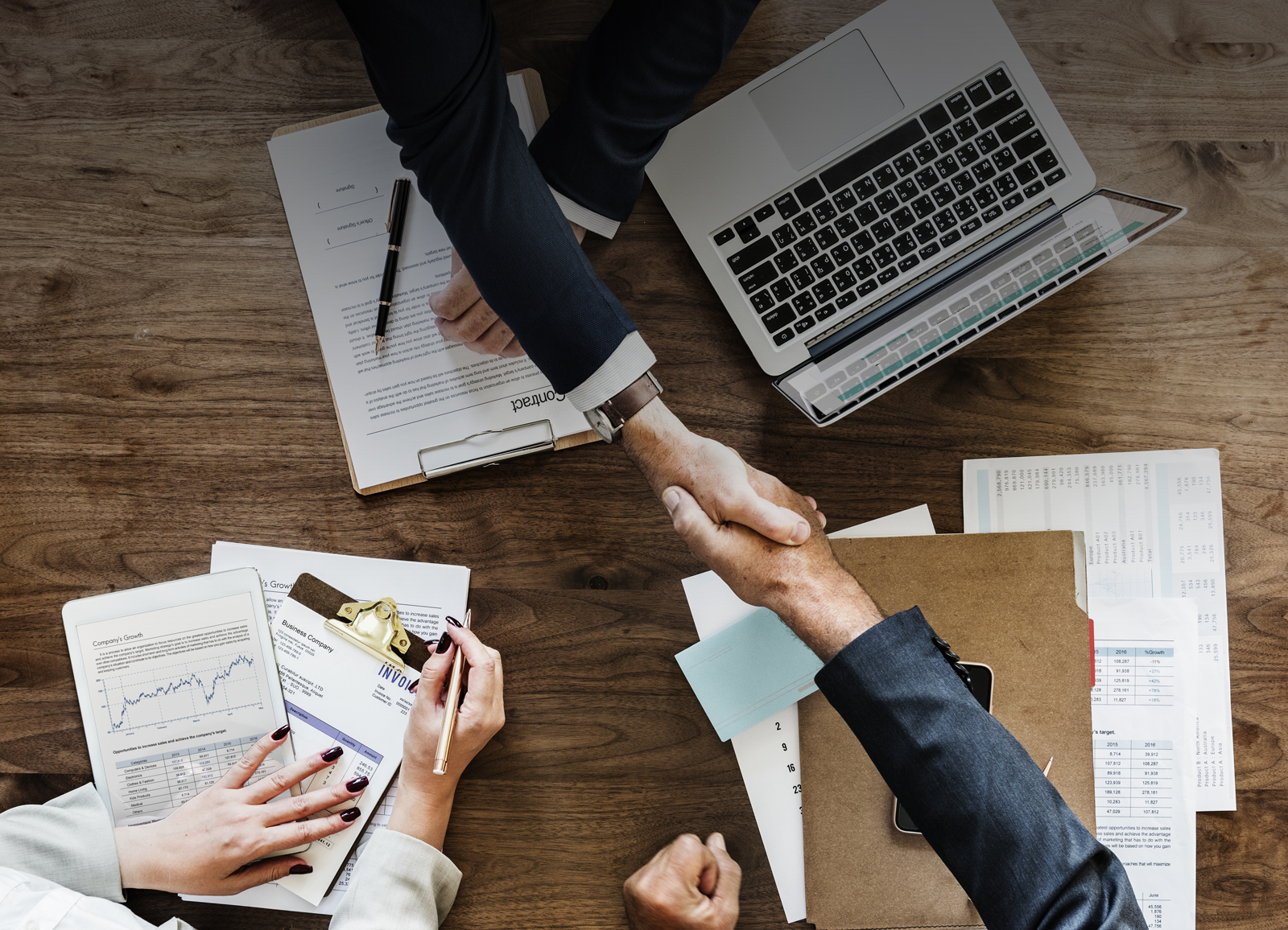 Business people shaking hands together
