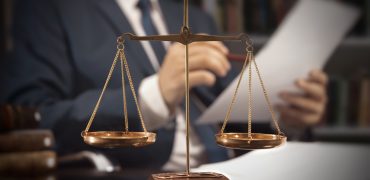 Weight scale of justice. Lawyer working in office Weight scale of justice. Lawyer, attorney, working in office. Consultant lawyer with paperwork